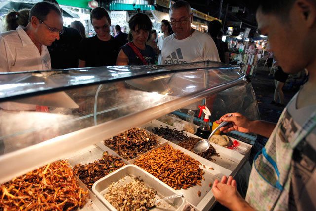 Photos: Sukree Sukplang/Reuters; Sakchai Lalit/AP. A la carte: bugs for sale in Bangkok