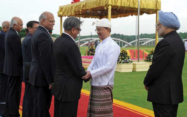 Photo: Shivraj. Waiting in line: Indian Prime Minister Manmohan Singh (right) and his delegation of businessmen greet Prime Minister Thein Sein in Myanmar earlier this year.