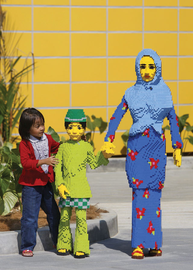 Photo: Khin Maung Win/AP Photo. Walk with me: a girl poses with figures made from Lego at Legoland Malaysia.