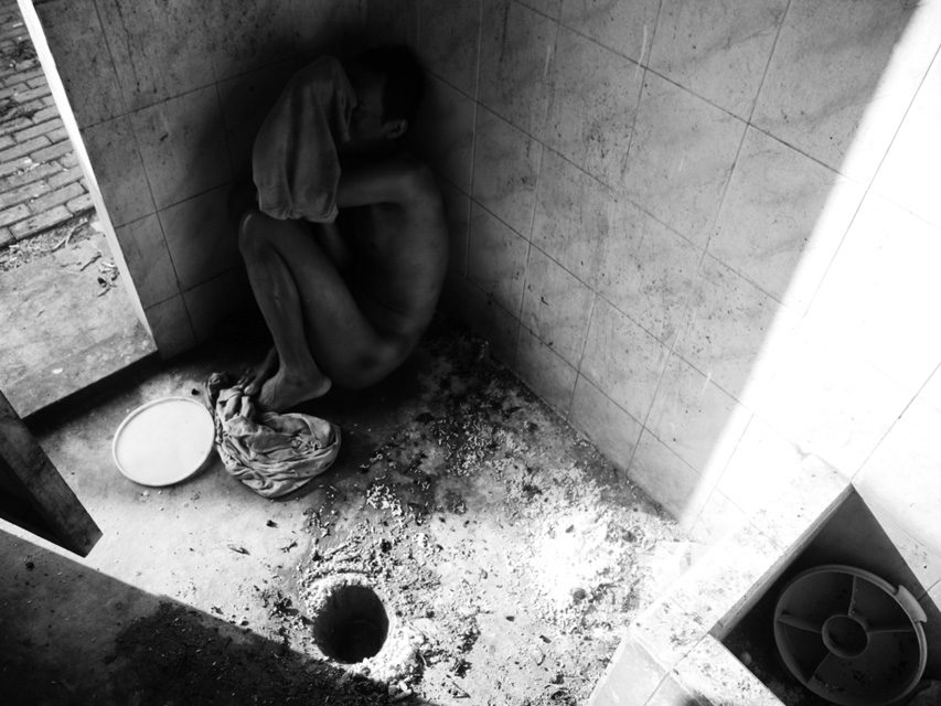 Photo by Dimitri Pilalis. A patient cowers in his cell at Yayasan Galuh rehabilitation centre. Conditions in mental institutions are often intolerable in Indonesia, a nation with an estimate of 19 to 27 million people with mental health problems but only 700 registered psychiatrists.