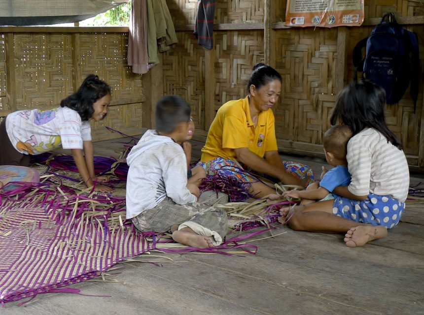 Photo by Girlie Linao. Dream weaver: displaced Muslim resident Fatima Ido, a 36-year-old mother, makes a mat at a refugee camp in the Philippines’ Maguindanao province.