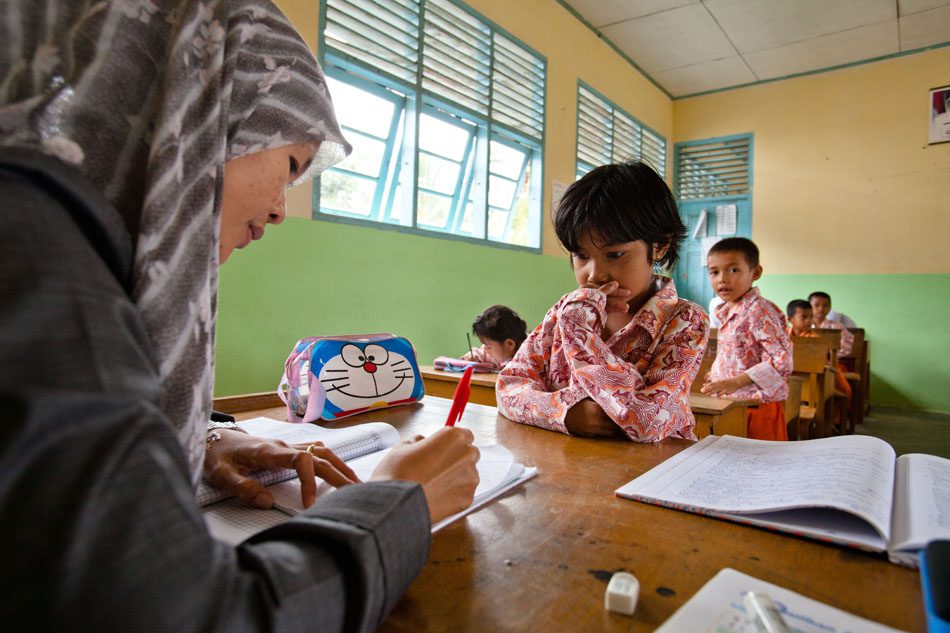 Photo by John Novis/Greenpeace. A model student: in Dosan, Indonesia, the entire community benefits from the profits of sustainable palm oil plantations.