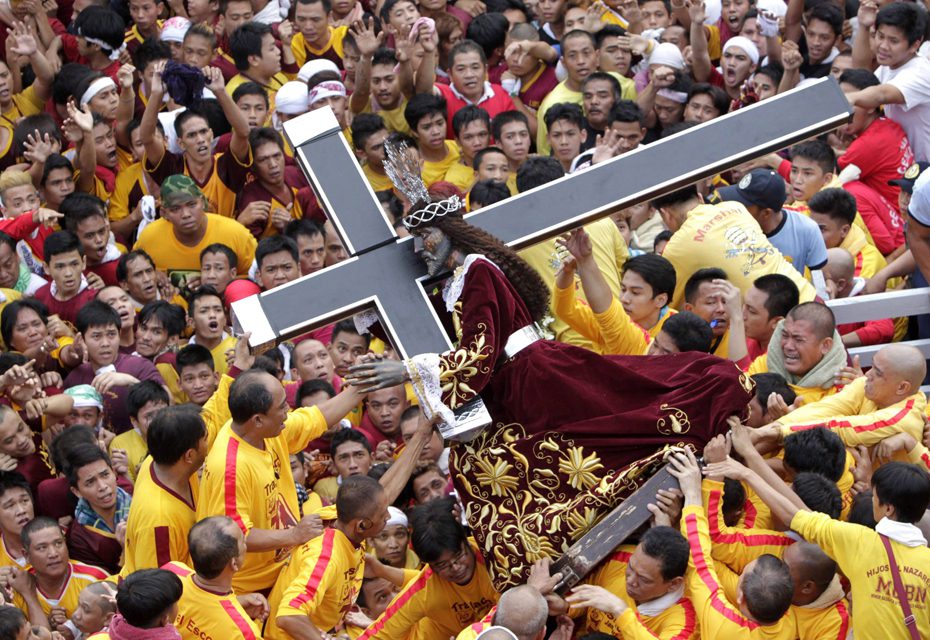 Photo by Erik De Castro / Reuters. Crossing over: From dawn to midnight up to 500,000 people joined in a parade to mark the start of an annual Catholic procession in Manila. Devotees carry a life-size wooden statue of Jesus Christ known as the Black Nazarene – an ancient relic believed to have healing powers, which was carved in Mexico and brought to the Philippines in the 17th century