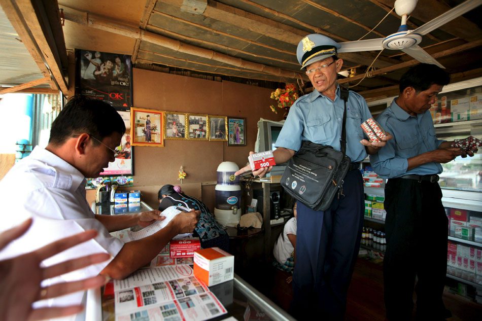 Photo by Paula Bronstein/Getty Images.Busted: Inspector Nuth Tith examines medicine in a pharmacy along the Cambodian-Thai border during a 2010 crackdown on counterfeit drugs