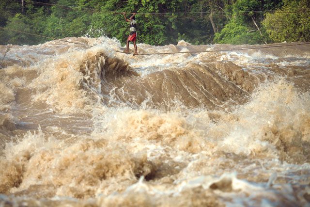 A man checks a trap near the Don Sahong dam site