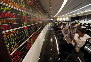 In numbers: investors monitor a board at a stock brokerage in Bangkok