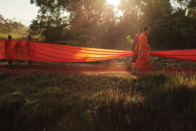 Colouring the debate: monks carry a saffron robe through a Cambodian village to raise awareness of environmental destruction. Thomas Cristofoletti 