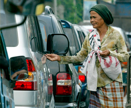 Helping hand: a woman begs for money on the streets of Jakarta, despite authorities banning beggars and street hawkers in a bid to bring order to the chaotic city of more than 11 million people. Photo: AFP/Ahmad Zamroni