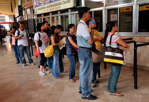 Desperate search: people are lining up in front of a job center. Photo: AFP/Jay Directo