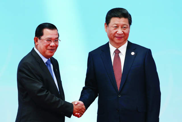 So close: Cambodia's Prime Minister Hun Sen (left) shakes hands with China's President Xi Jinping at this year's Conference on Interaction and Confidence Building Measures in Asia. Photo: AFP