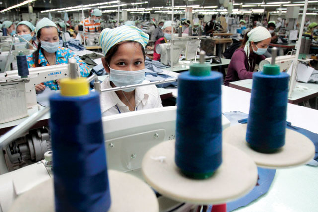 Lim Luck Hoeung (centre), 20, works at the W & D Cambodia Co. Limited garment factory in Phnom Penh. Photo: Chor Sokunthea/Reuters