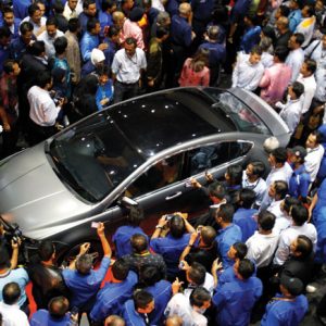 Get a look: people crowd around the newly unveiled, Malaysia-made Proton Preve during its launch in Kuala Lumpur in 2012. Photo: Bazuki Muhammad/Reuters