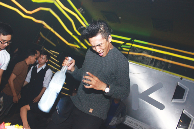 Huynh Gee, a local club promoter who also DJs under the moniker Just Gee, enjoys a drink at a trap event called Rave City