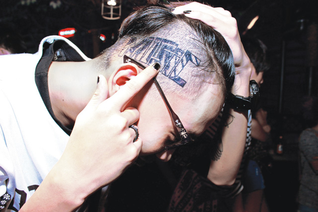 a reveller shows off some dubious body art at Rave City trap night at Olive Bay in Ho Chi Minh City