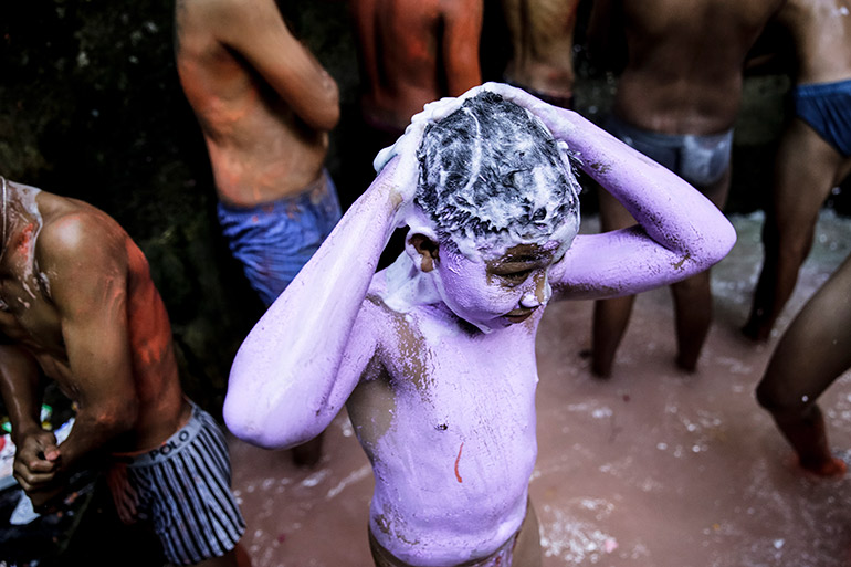 Once the festival has ended, participants wash off their paint at a holy spring