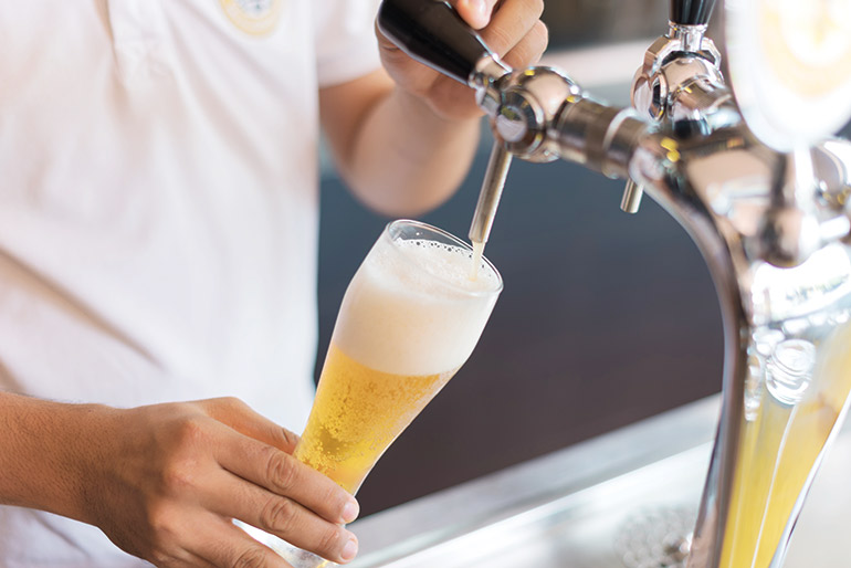 An "Apsara Gold" beer being poured at the Himawari Microbrewery in Phnom Penh