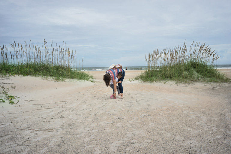 Beach fixes Kathleen’s shoe on an outing to St. Augustine’s beach in Florida. “This is where we would live if Ly could come back. This is where we both feel like we have family,” she says