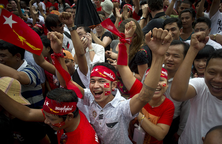 NLD supporters celebrate as election results are broadcast on a giant screen outside party headquarters in Yangon in November 2015