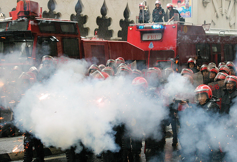 Police fire tear gas to disperse protesters during a 2007 Bersih rally.