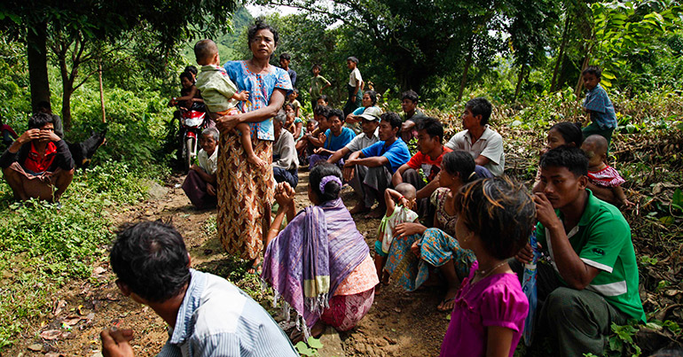 Villagers gather in the jungle as they flee from fights near the town of Maungdaw on the Bangladesh-Myanmar border, Rakhine State, western Myanmar, 13 October 2016.