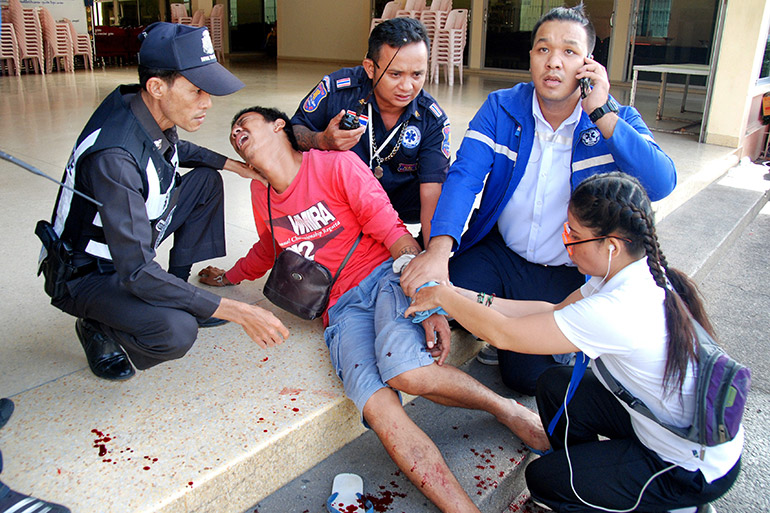 An injured person receives first aid after two bombs exploded on August 12, 2016 in the Thai seaside resort of Hua Hin