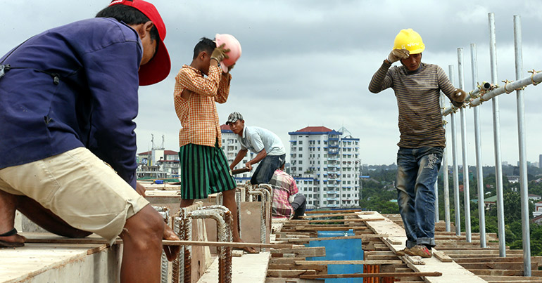 Workers gather on top of a construction site in Yangon, Myanmar