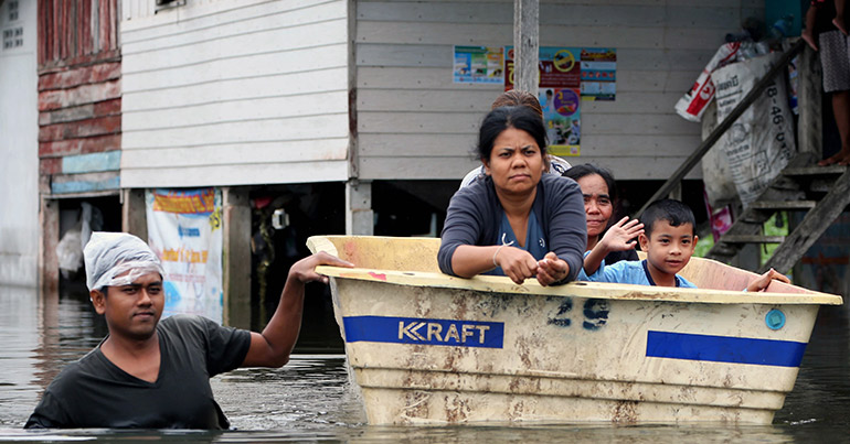 Thai villagers wade through floodwaters at a village in Nakhon Si Thammarat province, southern Thailand, 08 January 2017.