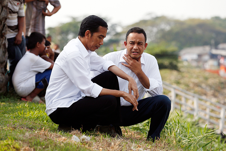 Candidate Anies Baswedan, a former spokesperson for President Joko Widodo during his presidential campaign, speaks to Widodo in Jakarta, Indonesia