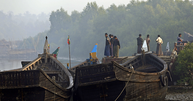 Members of the Rohingya minority group stand near the border checkpoint of Maungdaw town, Bangladesh-Myanmar border, Rakhine State, western Myanma