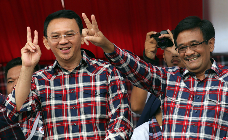 Basuki 'Ahok' Tjahaja Purnama (L), Jakarta governor candidate accompanied by his running mate Djarot Saiful Hidayat (R) greets the crowd during a campaign rally in Jakarta, Indonesia