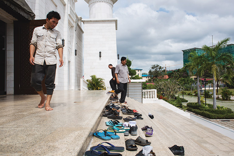 worshippers exit Al-Serkal Mosque in Phnom Penh after the day’s noon prayers