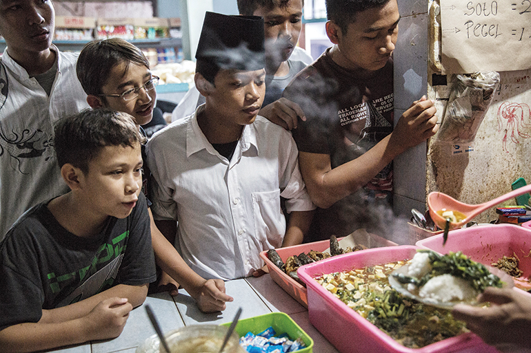 young pupils wait eagerly to purchase food from the school’s canteen