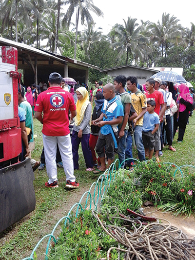 the Philippines Red Cross distributes aid packages in Basilan in July 2016