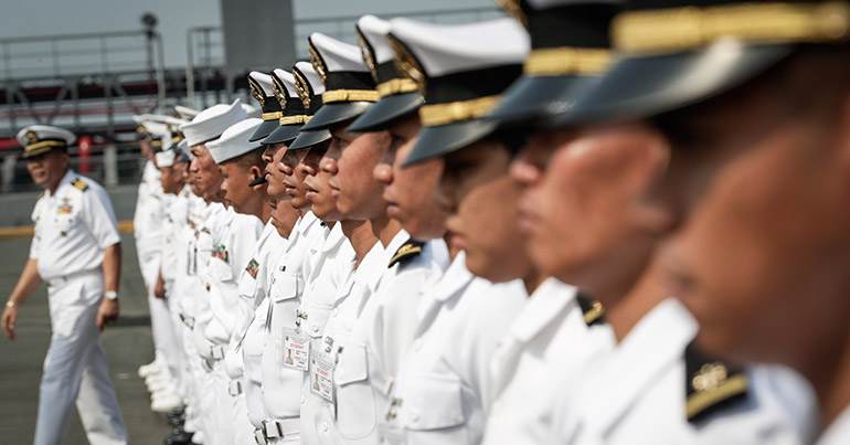 Philippine Navy officers gather during a ceremony at a port in Manila, Philippines