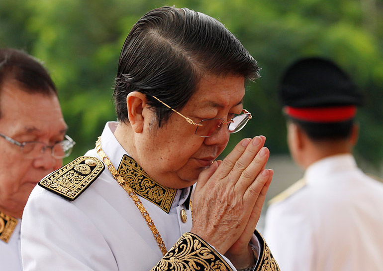 Sok An prays during a wreath-laying ceremony at a statue of former King Norodom Sihanouk in Phnom Penh, Cambodia