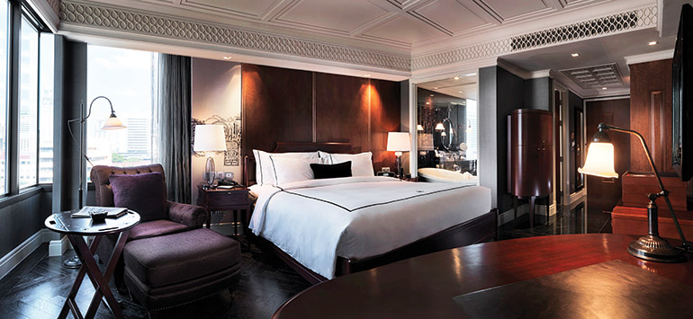 The Dowadueng Corner Deluxe room, featuring a claw-foot roll-top bathtub with separate shower, hand-painted basins, Venetian mirrors and black marble floors. 