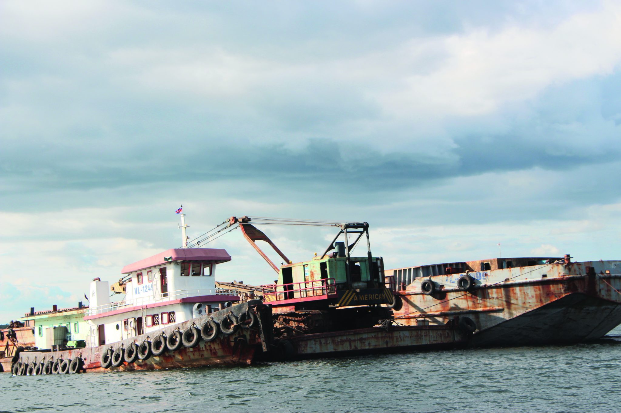 Sand dredging barges lined up in the small fishing village of Koh Srolav. Photo: Cambodian Center for Human Rights