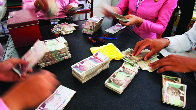 A group of Chamroeun microfinance employees working in the MFI's Pochentong branch office. Photo: Godong/BSIP