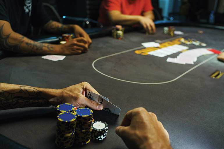 A player checks his cards during a game at the underground venue. Photo: Sam Jam