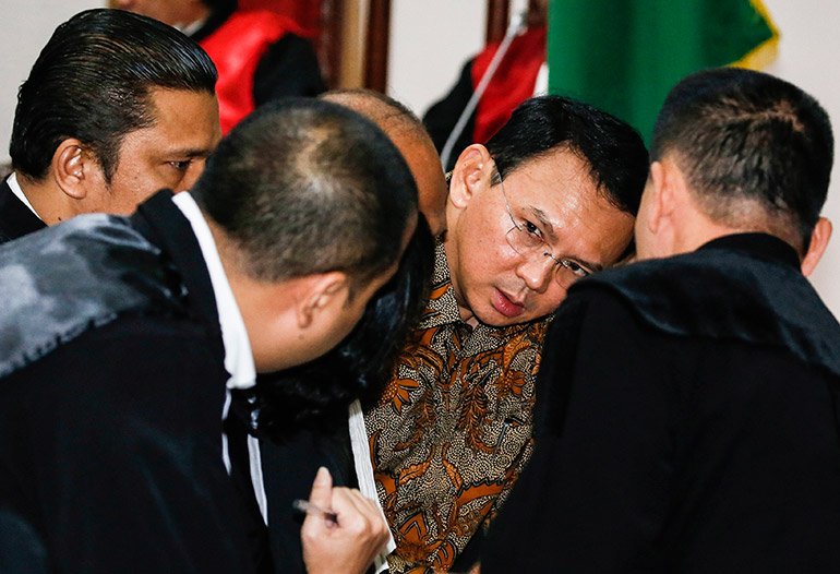 Jakarta's governor Basuki Tjahaja Purnama popularly known as 'Ahok' talks to his lawyers inside the courtroom during his blasphemy trial at the North Jakarta District Court in Jakarta, Indonesia, 11 April 2017. Photo: EPA/Beawiharta/Pool