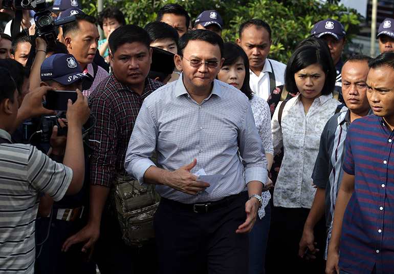 Basuki 'Ahok' Tjahaja Purnama (C), the current governor of Jakarta, arrives at a polling station during the second round of regional elections in Jakarta, Indonesia, 19 April 2017. Unofficial polls show that Ahok lost the election by a considerable margin. Photo: EPA/Bagus Indahono