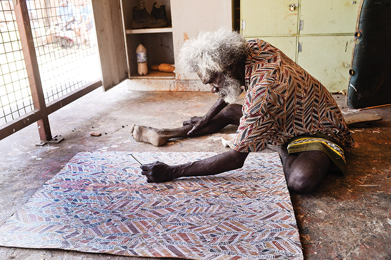 Injalak artist Glen Namundja at work in the arts centre. Photo: Mark Roy