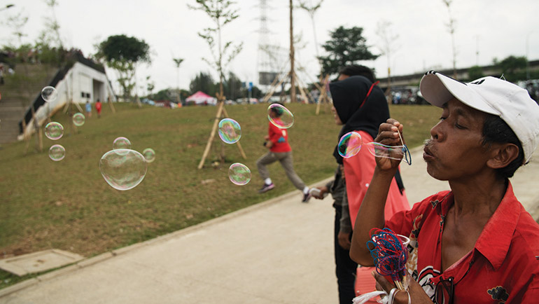 Many Jakartans have been taking full advantage of Kalijodo park (right) since it opened in late February, though the transition has not been so easy for those pushed out to make way for the public project. Photo: Arman Dzidzovic