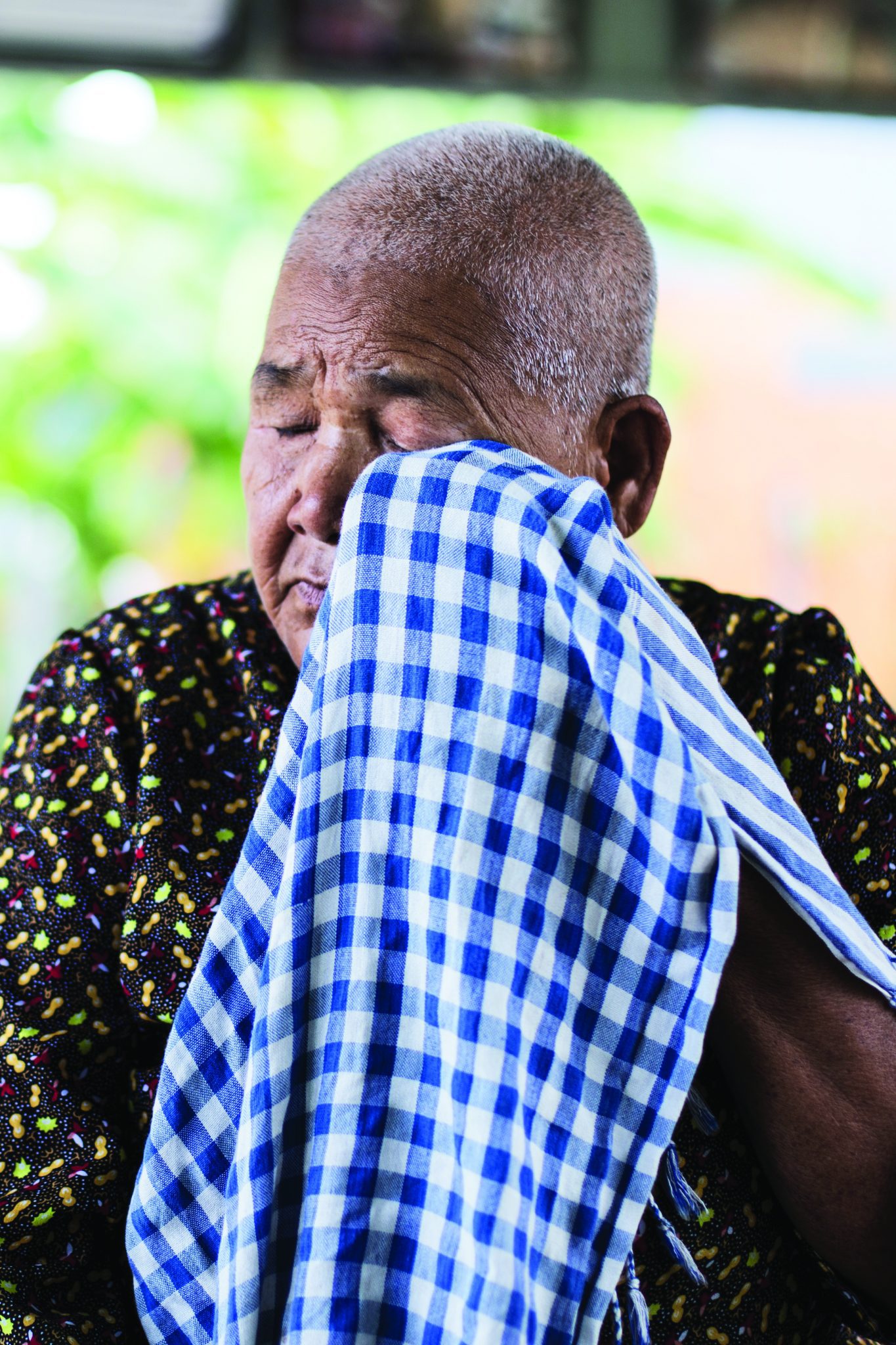 Kem Ley’s mother, Phok Se, wipes away tears while talking about her son. Photo: Southeast Asia Globe/Emil Kastrop