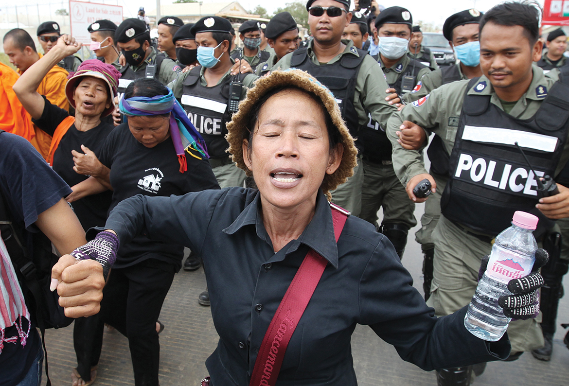 Police officers block activists during last year's 'Black Monday' protests in Phnom Penh