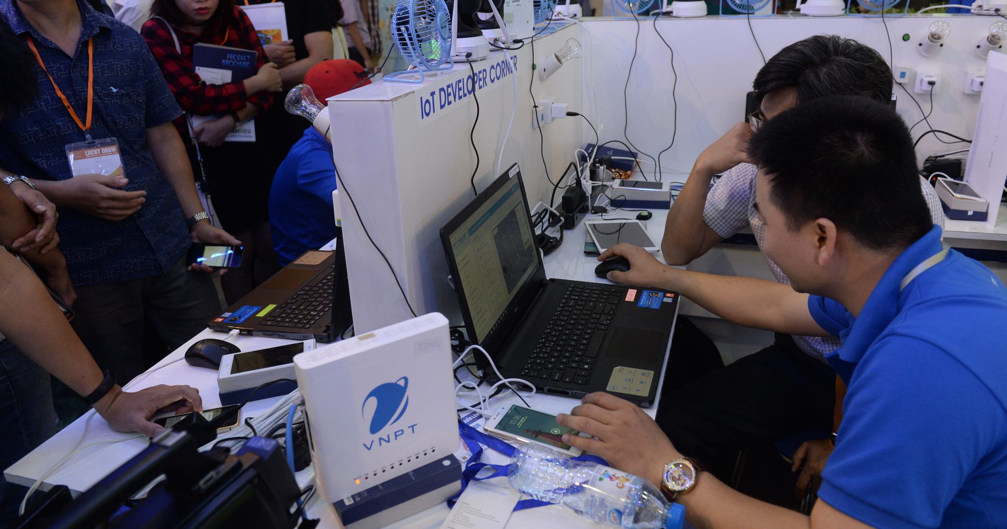 A technician from Vietnam Posts and Telecommunication helps people during a local telecommunication, information technology and communication fair Photo: Hoang Dinh Nam / AFP