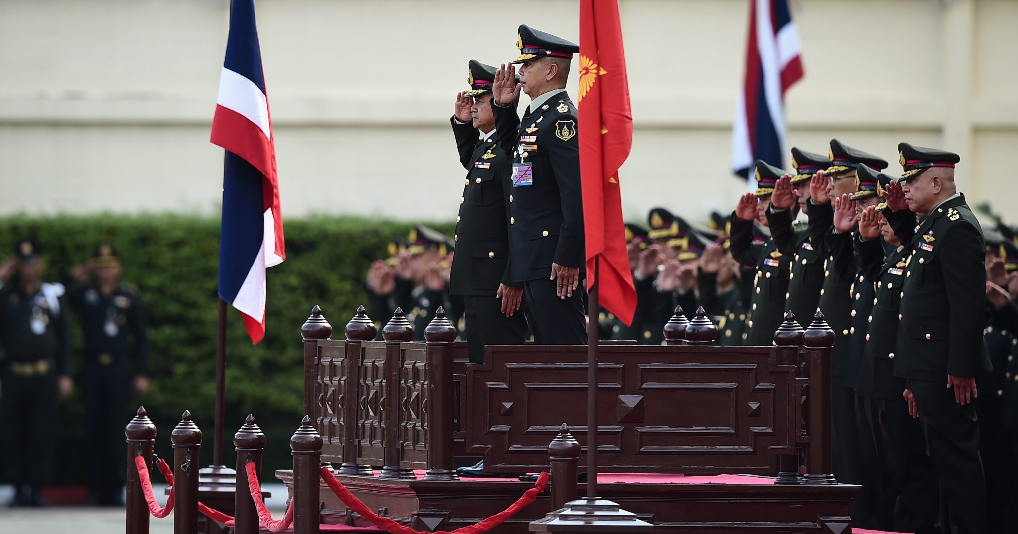 Outgoing Royal Thai Army chief General Chalermchai Sitthisad (center-L) and his successor General Apirat Kongsompong (center-R) Photo: Lillian Suwanrumpha / AFP