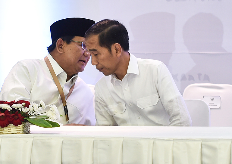 incumbent President Joko Widodo (R) and Prabowo (L) talk