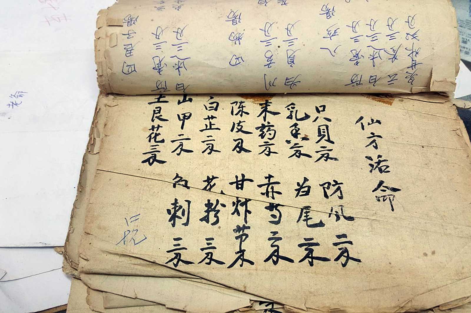 A traditional Chinese medicine recipe to clear toxicity in the body calling for pangolin scales, herbs and roots, at a traditional Chinese medicine store in the Sheung Wan district of Hong Kong. On a winding Hong Kong street where shops keep a dizzying array of dried produce, one highly valued ingredient is still being sold despite being subject to an international ban: deep-fried scales of endangered pangolins. Photo: Joanna Chiu/AFP