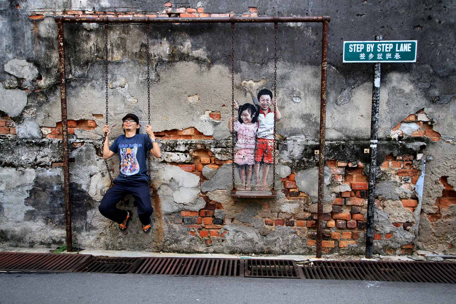 Children On A Swing, another famous piece of George Town street art. Photo: Mohd Fazlin / Flickr creative commons